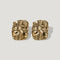 Pair of gold-tone abstract sculpted stud earrings on a light background