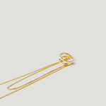 Gold twisted pendant necklace with delicate chain on white background