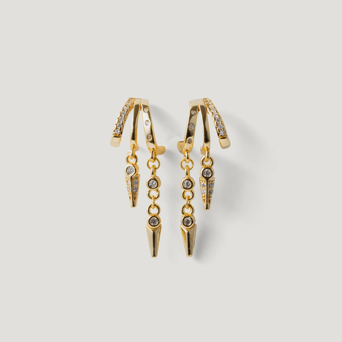 Gold drop earrings with chain and crystal accents on a white background