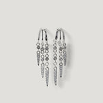 Silver hoop earrings with multiple dangling spike and round crystal accents on white background