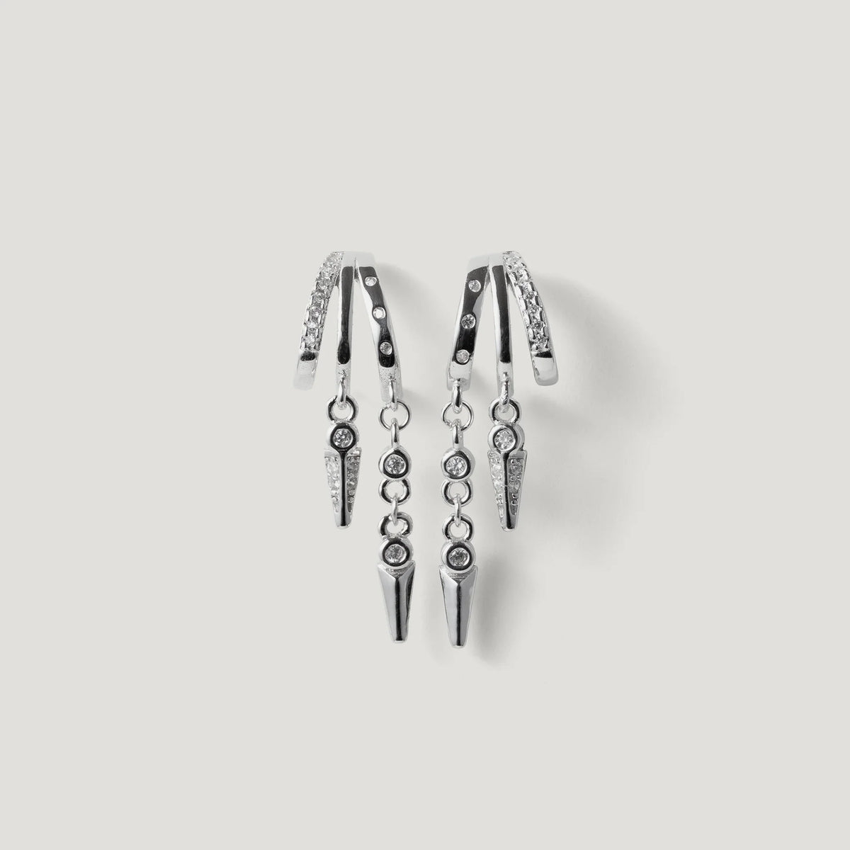 Pair of silver hoop earrings with hanging spike charms and small crystal accents