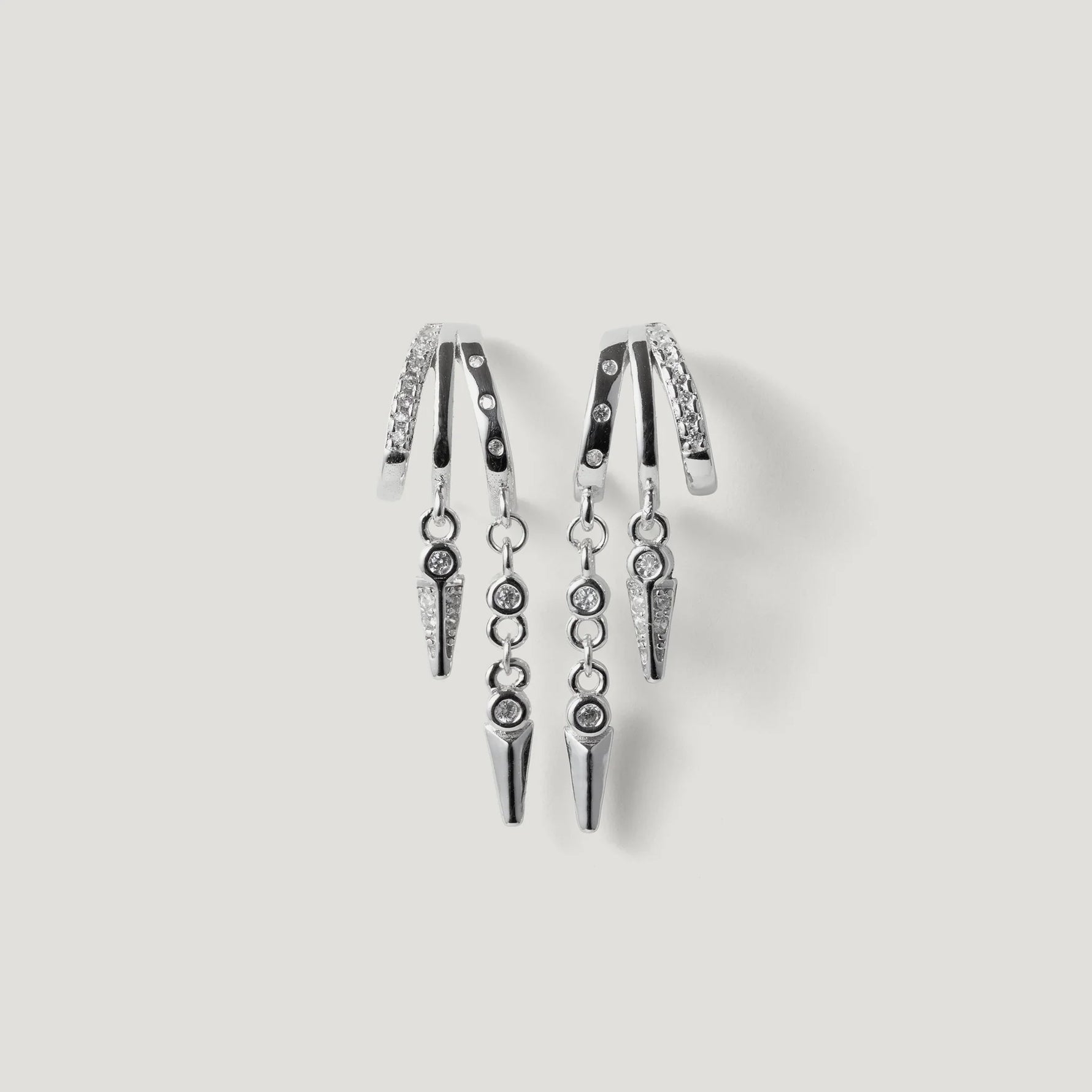 Pair of silver hoop earrings with hanging spike charms and small crystal accents