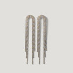 Long crystal fringe drop earrings with gold-tone setting on white background