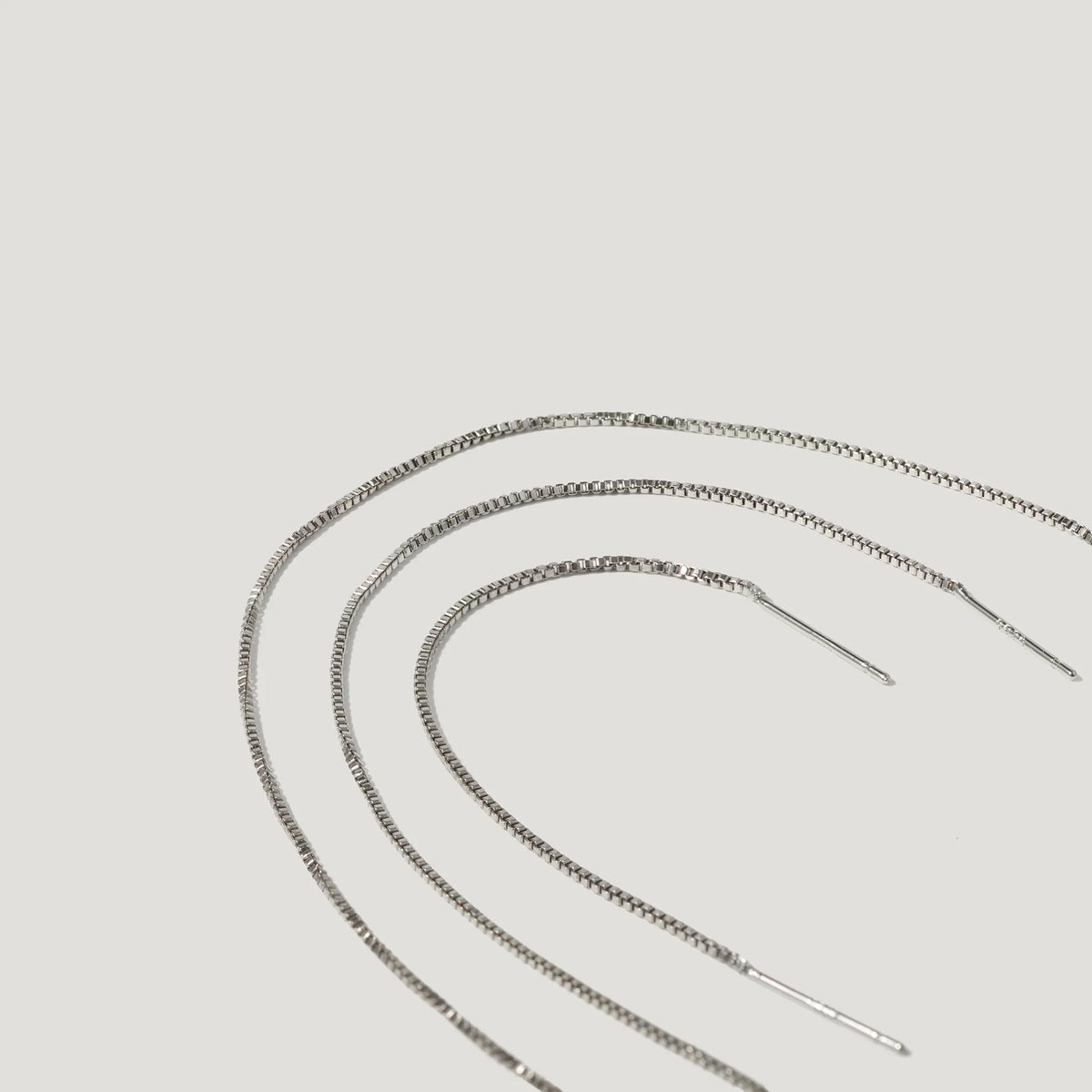 Silver box chain threader earrings on a white background
