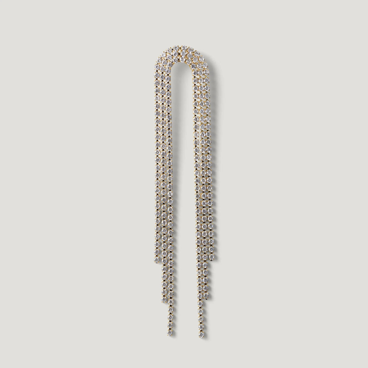 Gold-tone dangling crystal chain earring with elegant draped design on white background