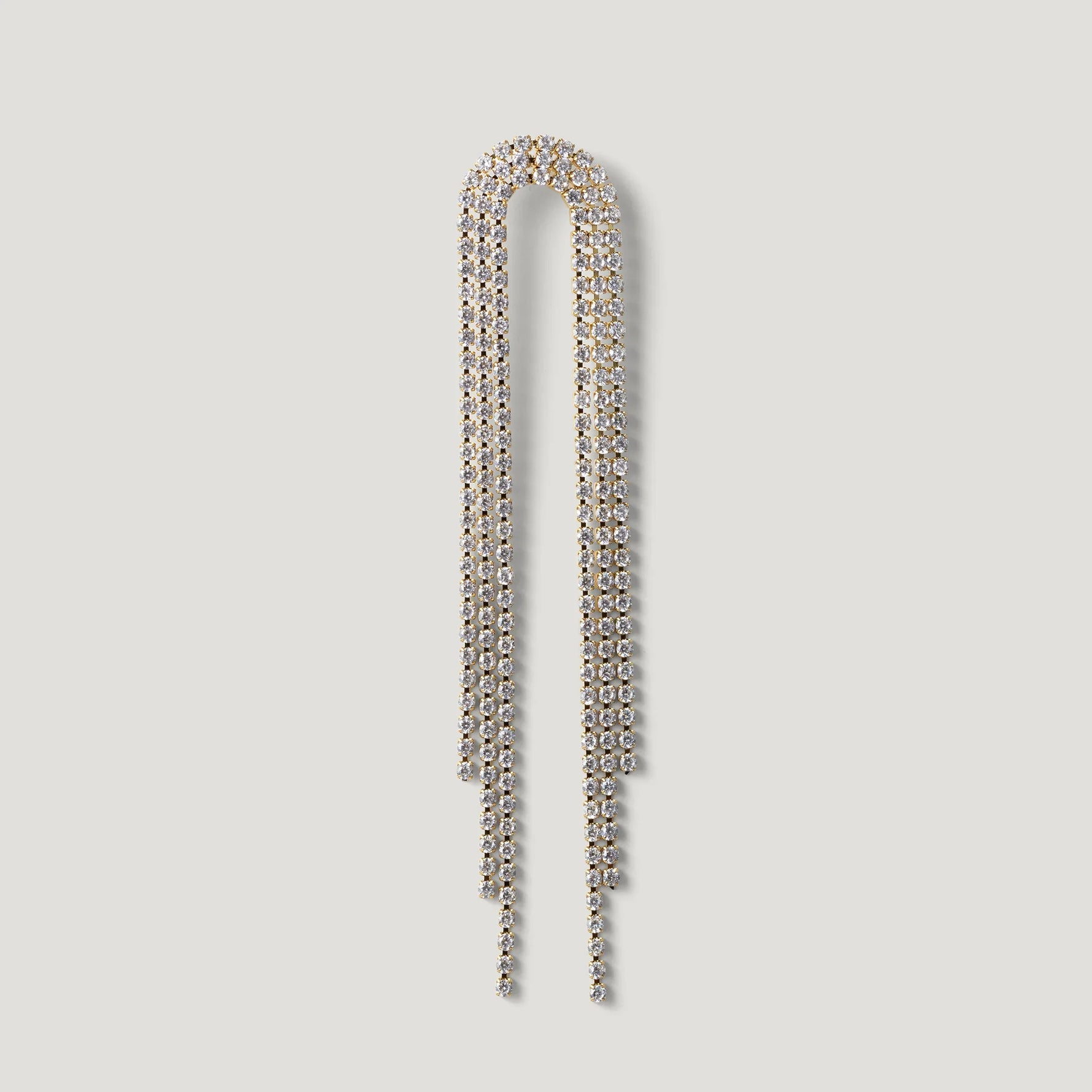 Gold-tone dangling crystal chain earring with elegant draped design on white background