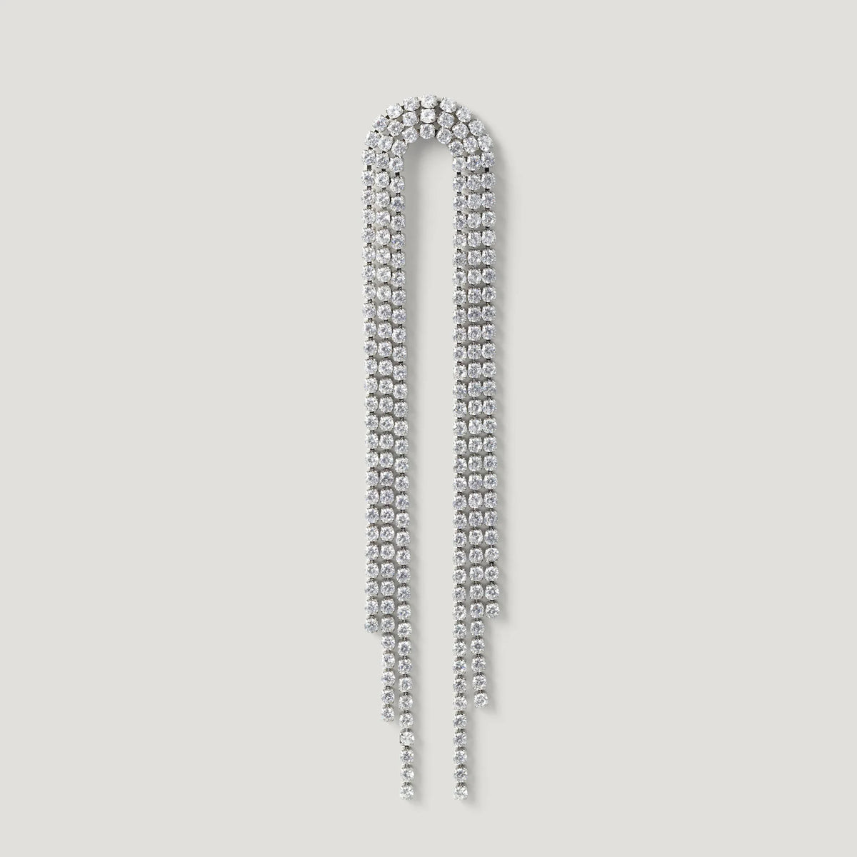 Long silver rhinestone drop earring with curved top and cascading strands on light background