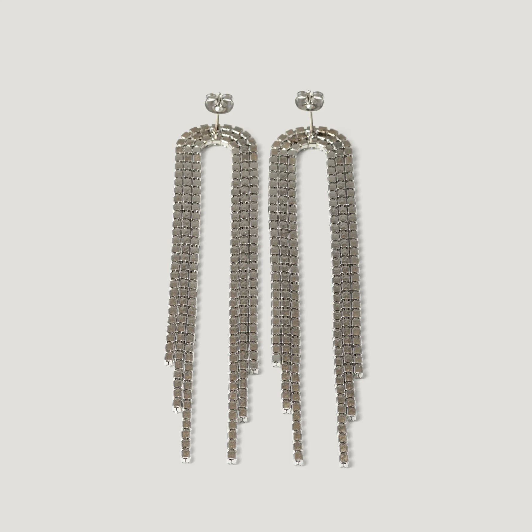 Long silver chain drop earrings with three-tiered geometric strands on white background