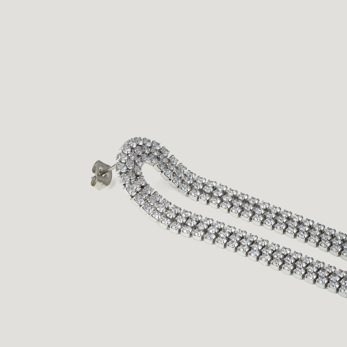 Silver double row rhinestone drop earring on white background