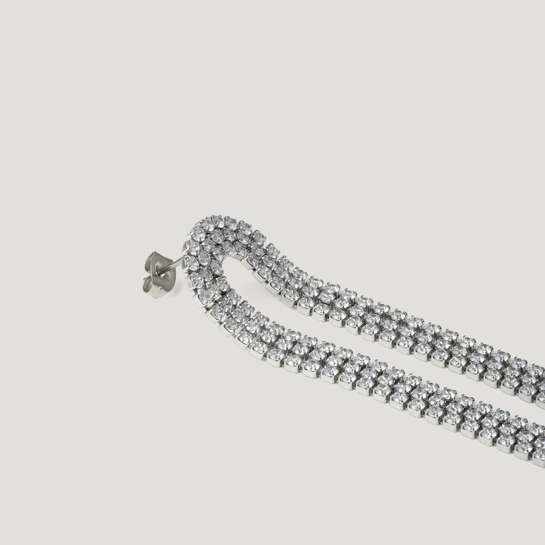 Silver double row rhinestone drop earring on white background