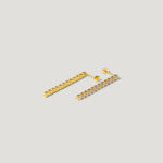 Gold bar stud earrings with clear gemstones on a light background