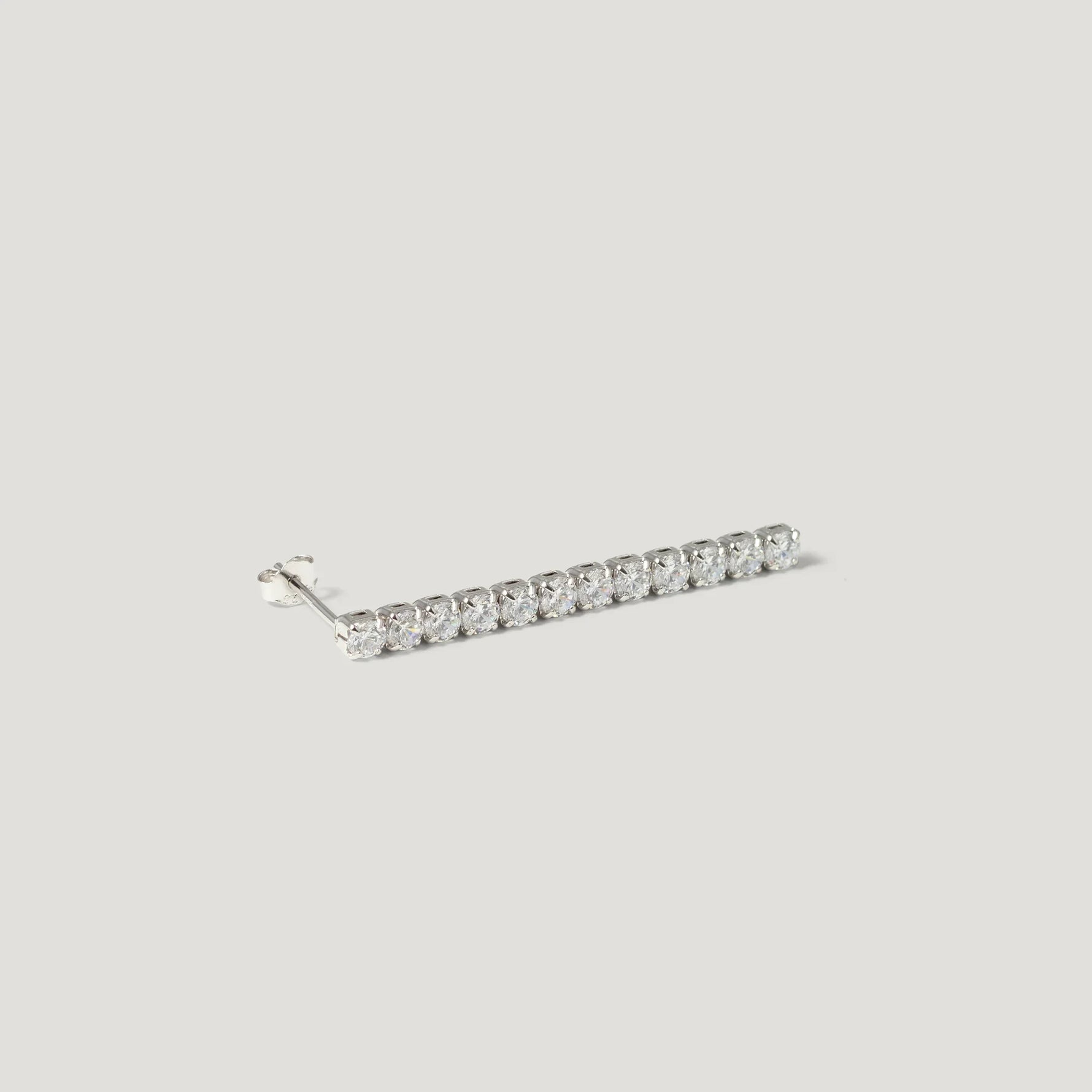 Minimalist silver bar stud earring with clear gemstones on white background