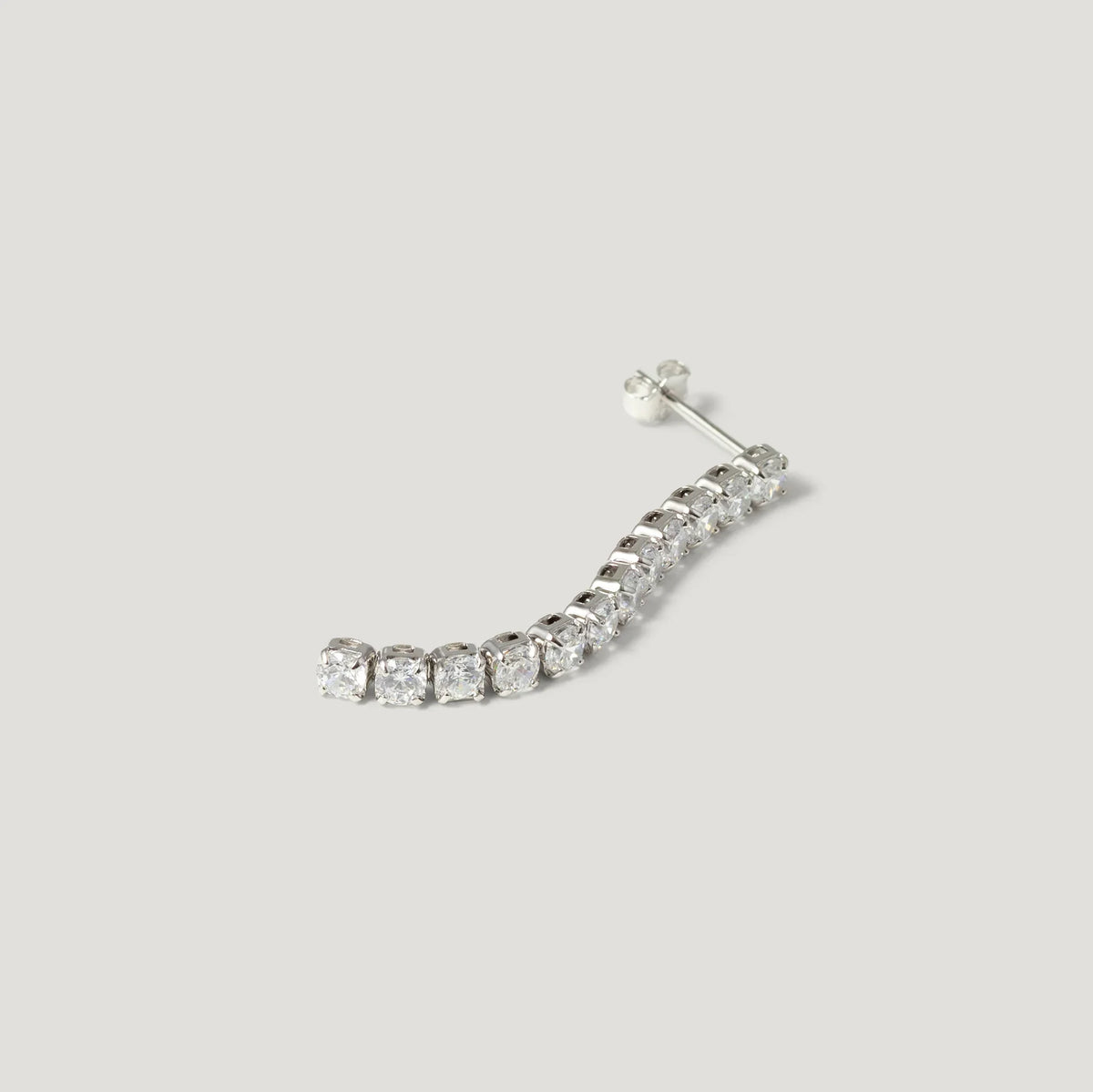 Curved sterling silver ear climber with clear gemstones on white background